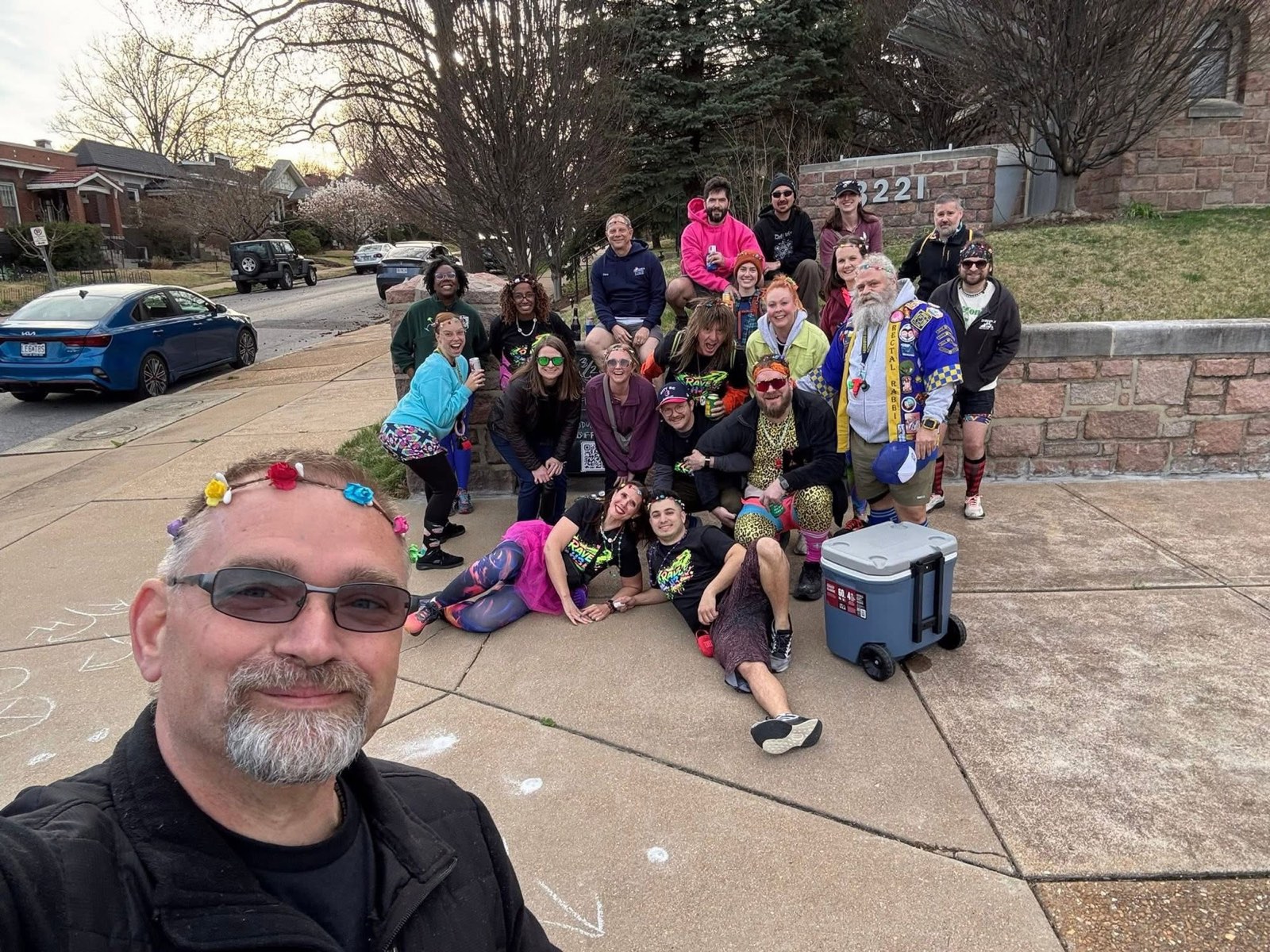 The Rave H3 pack in neon, glow sticks and tutus, grinning on a sidewalk at the on-in